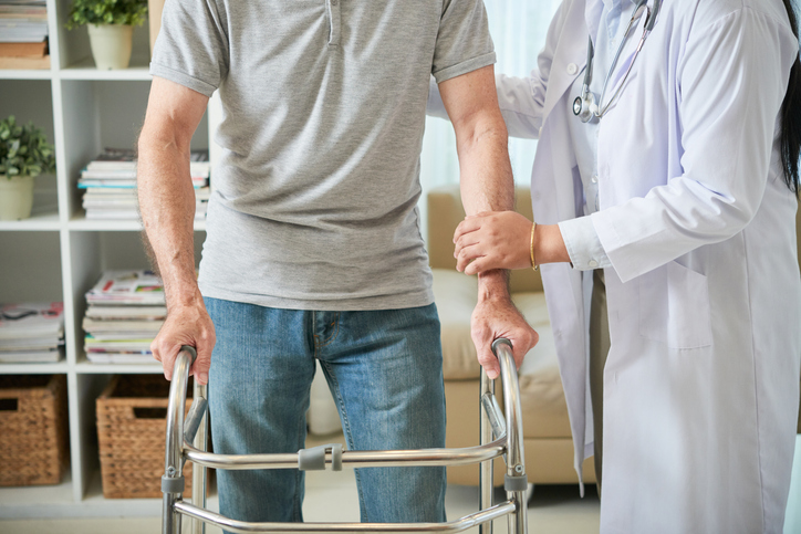 Activities of Daily Living: man learning to use a walker.